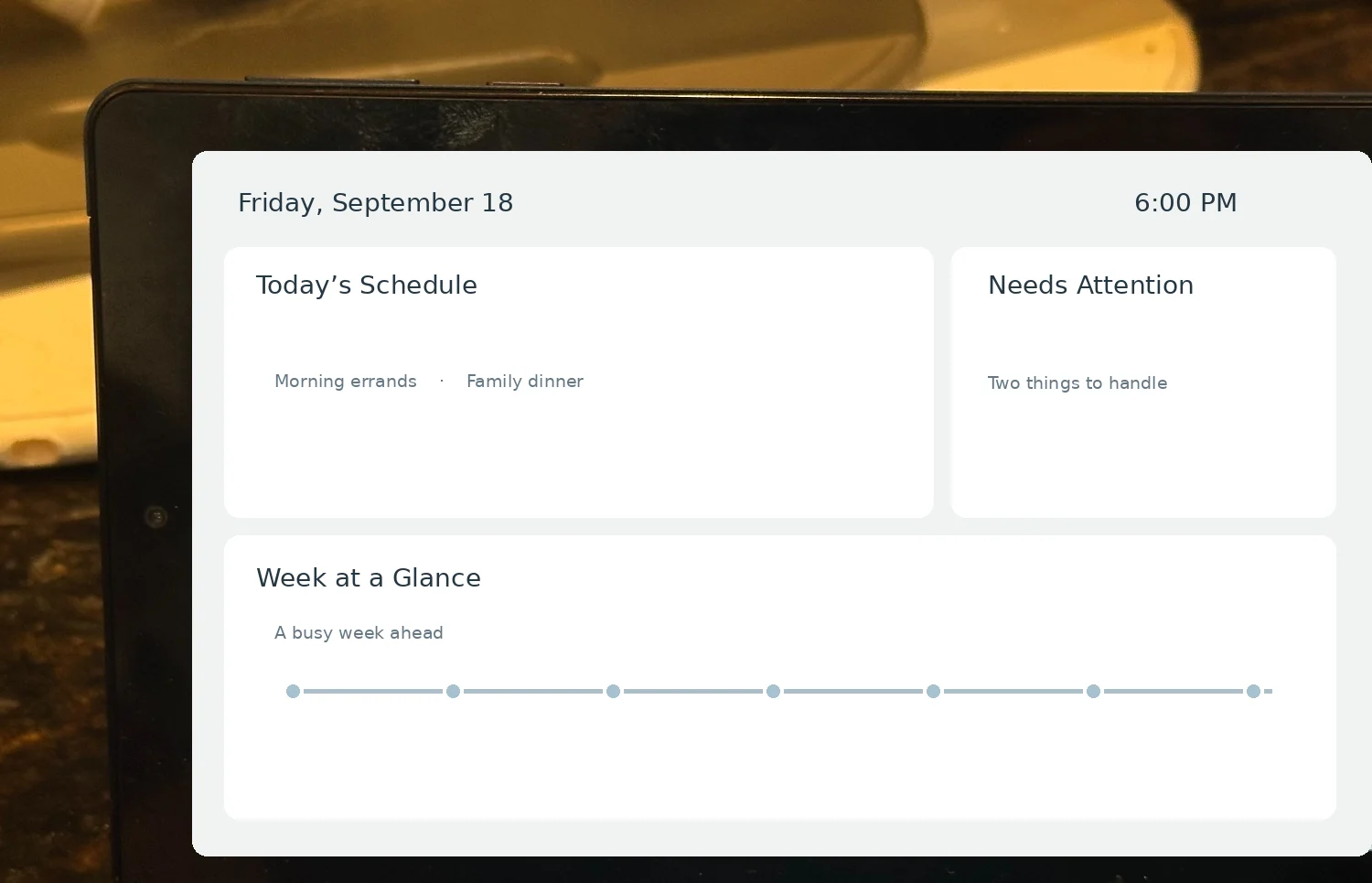 Actual kitchen tablet photograph; private schedule details on its screen have been blurred.